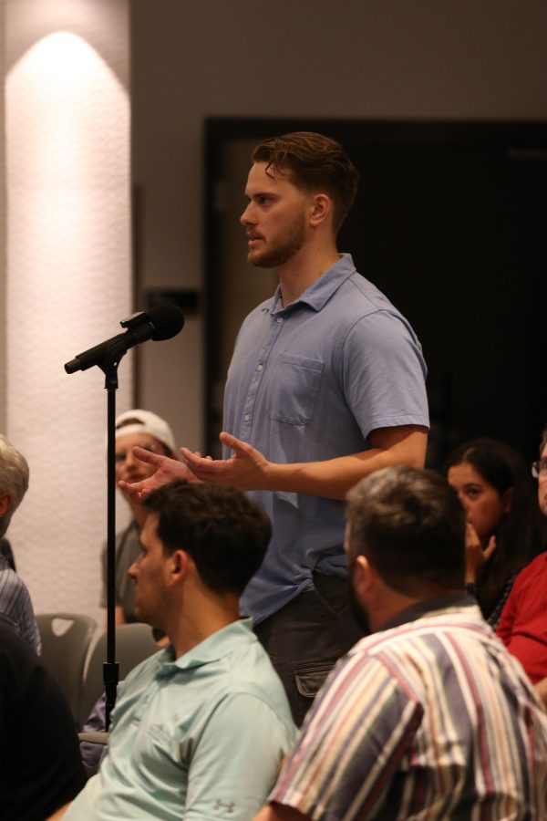 A student at the microphone during Q&A